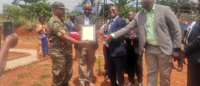 Honorable Minister and District leadership receiving a certificate of completion from the UPDF Engineering brigade